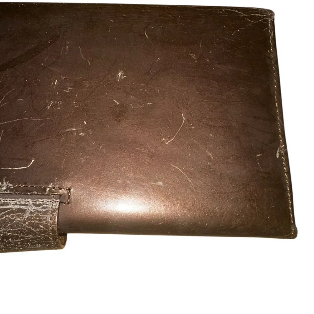 Yves Saint Laurent Tan Leather Wallet with Gold Clasp with marks and scratches.